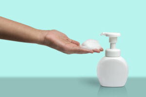 Woman,Hand,Take,Some,Cleaner,Foam,From,Pure,White,Plastic