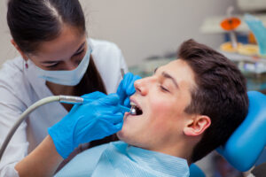 Man having teeth examined at dentists dental treatment